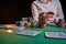 The croupier at the gaming table in the casino, raises bets with chips. Gaming business black jack, poker. With space for design