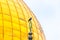 A crow sits on a Muslim symbol at the top of Dome of the Chain, against the backdrop of the Dome of the Rock on the Temple Mount