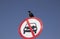 Crow sitting on the road sign