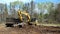 CROW WING CO, MN - 10 MAY 2023: Excavator scoops load of brown soil