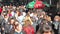 Crowd of anonymous people walking on busy street