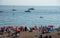 Crowd of British people sunbathing swimming and relaxing in the beach at summer. Leisure time outdoor