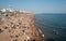 Crowd of British people sunbathing swimming and relaxing in the beach at summer. Leisure time outdoor