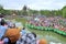 Crowd of Buddhists are offering incense to Buddha with thousand hands and thousand eyes in the Suoi Tien park in Saigon