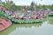 Crowd of Buddhists are offering incense to Buddha with thousand hands and thousand eyes in the Suoi Tien park in Saigon