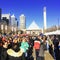 A crowd is busy at Churchill Square in front of city hall in downtown Edmonton, Alberta, Canada.