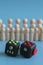 Crowd calm concept. answer how to calm the crowd. Cube stress reliever and wooden figures on a blue background. vertical photo