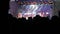 Crowd at concert. Cheering crowd in front of bright colorful stage lights. silhouettes of concert crowd in front of