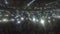 Crowd of fans waving phones in darkness. Lights sparkle during popular slow song