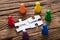 Crowd Funding Jigsaw Pieces Surrounded By Colorful Figurines