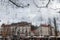 Crowd gathered for Christmas market on Presernov Square with Tromostovje bridge and Ljubljana castle in the background.