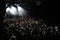 A crowd of heads enjoying music at a nightclub concert venue