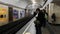 Crowd of masked people on the platform in the subway is waiting for the train