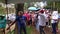 Crowd of needy people gathers in the park to receive donations of various relief food packs from fraternity volunteers