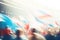 Crowd of Olympic fans with flags at the stadium. Blurred background