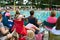 Crowd Of Parents Sit Poolside To Watch Swim Meet