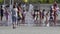 Crowd of People cool off in water fountains at central square in city