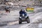 crowd of people at lahul spiti showing small food outlets, adventure sports with family riding ATV on the snow covered