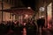 Crowd of people sitting at the terrace of a Belgrade Bar Cafe, being heated for winter with an electric heating