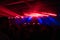 Crowd of people and stage lights at techno party