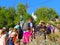 Crowd of people, trip in Samaria gorge, Crete, Greece, monument to Parthenios Kelaidis