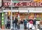 A crowd of people wait in line outside the famous Katzâ€™s Deli in the Lower East Side of New York City on Houston Street