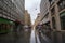 Crowd of people walking in a pedestrian street of Brno, Koblizna Ulice, during a rainy afternoon surrounded by shops and boutiques