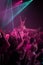 Crowd surf, neon and people at music festival with neon pink lighting and energy at live concert event. Dance, fun and