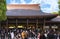 Crowd of tourists in front of the hall of worship in the Shinto shrine of Meiji-Jingu.