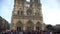 Crowd of tourists near beautiful Notre-Dame de Paris, panorama of cathedral