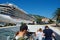 a crowd of tourists near the pier with a cruise ship on street of Kotor city Montenegro, a bright sunny day, mountains and palm