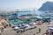 Crowd of tourists walk along Marina Grande, sightseeing boats, ferry and taxi at Capri Island, Italy