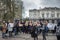 Crowd of University students seen at a peaceful protest, while holding protest signs.