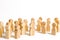 A crowd of wooden figures of people on a white background. Social survey and public opinion, the electorate. Population