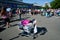 Crowd of young people shopping on the street flea market at sunny morning