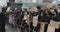 Crowd of young protestors with mixed nationalities black and caucasian holding up signs against Police Brutality and