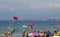 Crowded beach with pedal boats and parasail