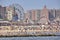 Crowded Coney Island beach and amusement park on a warm, hazy day.