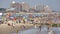 Crowded Coney Island beach on a warm, hazy day.