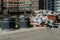 Crowded garbage cans in the courtyard of a residential apartment building. Garbage sorting containers. Trash is