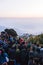 Crowded people are waiting for the first light in the dawn of new year`s day with trees in background at Tiger Hill, Darjeeling.
