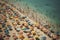 Crowded sandy beach with tourists relaxing by the sea, created with generative AI