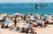 Crowded sandy Conceicao beach in Cascais near Lisbon, Portugal during the summer