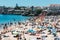 Crowded sandy Conceicao beach in Cascais near Lisbon, Portugal during the summer