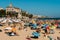 Crowded sandy Tamariz beach in Estoril near Lisbon, Portugal during the summer