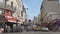 Crowded street with people and cars traffic in center of Paris