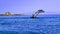 A crowded white dive platform in the middle of the blue sea at Rhodes island Greece during summer against the clear blue sky