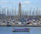 Crowded yacht harbour with lighthouse and dinghies