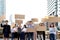 Crowds of discontented people holding blank banners placards protesting at downtown city, group of angry men and women rebellions