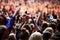 The crowds are enjoying the atmosphere. Shot of a crowd of young people at an outdoor music festival.